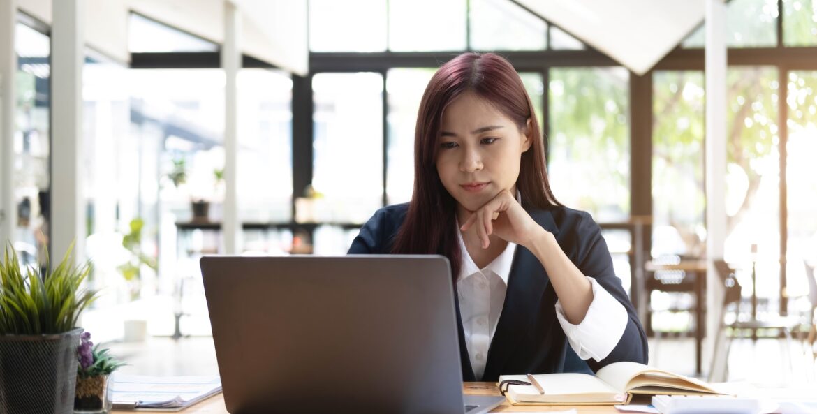 Asian woman working laptop. Business woman busy working on laptop computer at office.